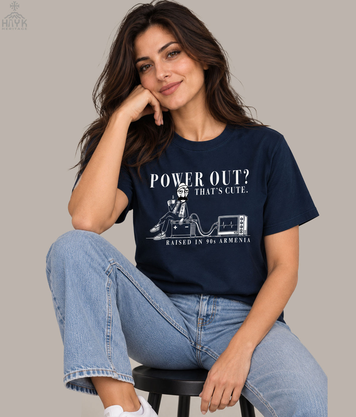 Norek Aram 90s Armenia blackout humor tee — man with coffee, two clips, a car battery and a television, Hayk Heritage design.