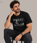 Hayk Heritage "Norek Aram — Raised in the 90s" Armenian humor t-shirt: cartoon man sipping coffee on a car battery wired to an old TV, with "Power Out? That's Cute" and "Raised in 90s Armenia" text.